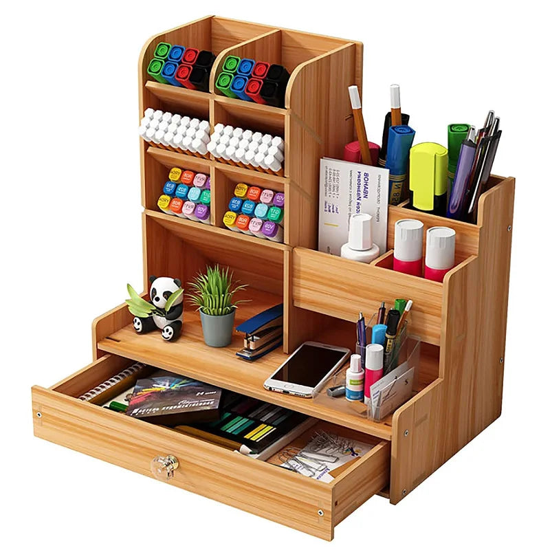 Wooden desk organizer with drawer holding pens, stationery, and office supplies on a desk
