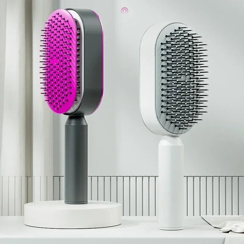 Two grooming brushes, one with a pink bristle head and gray handle, the other with gray bristles on a white background. Self cleaning hair brush with one-key hair removal, anti-static scalp massaging comb for women