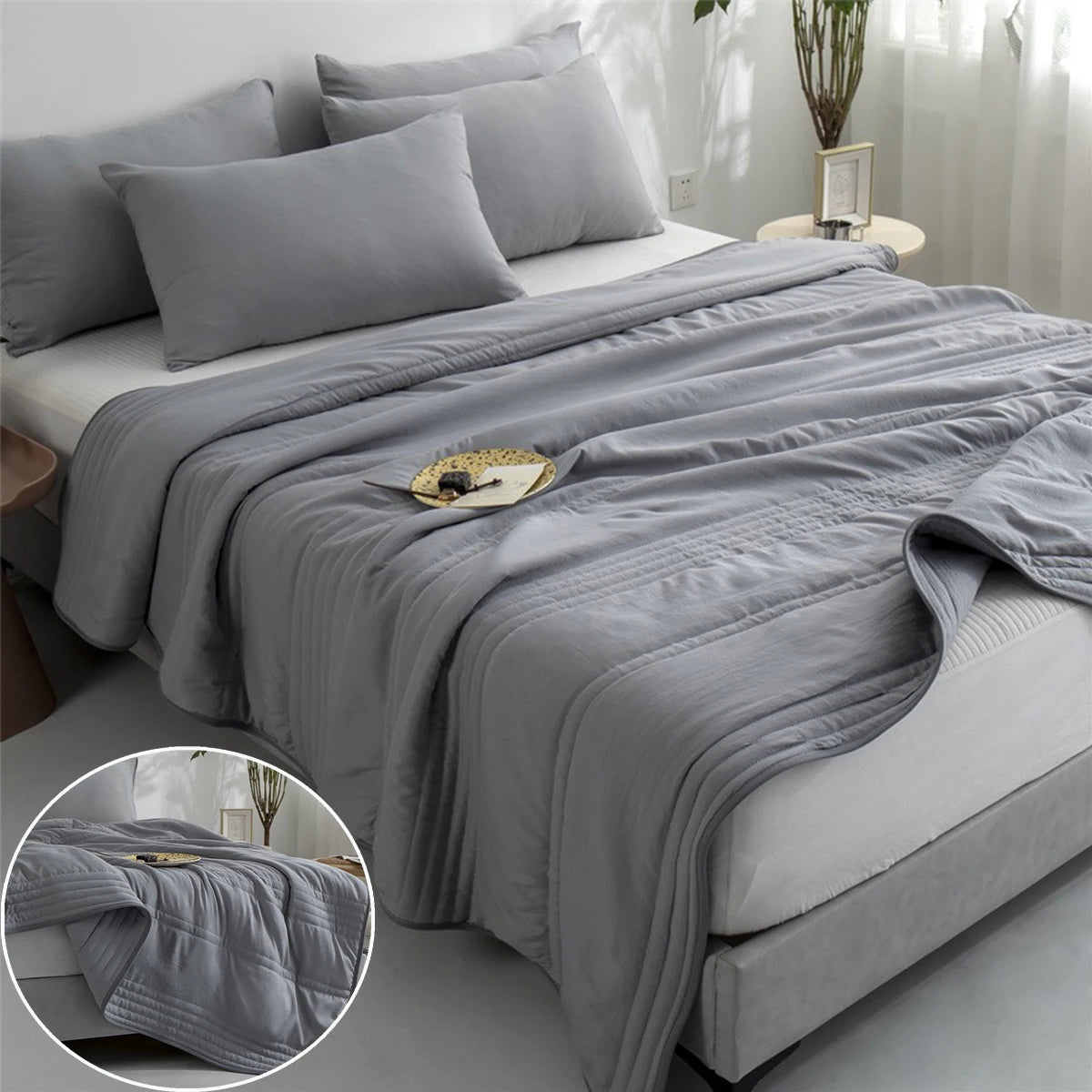 Gray comforter on a bed with a close-up of the texture in a corner.