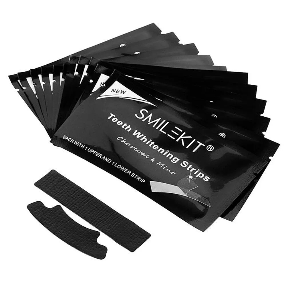 SMILEKIT teeth whitening strips packaging with two strips displayed in front on a white background. Box of 14 charcoal teeth whitening strips with bamboo formula for coffee and tea stain removal