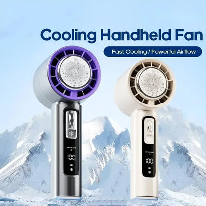 Two cooling handheld fans with digital displays against a mountainous background. Portable handheld USB rechargeable fan with semiconductor cooling technology and LED display showing speed and battery status