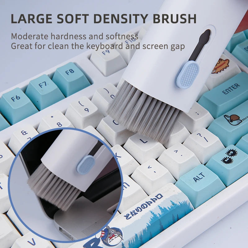 Keyboard cleaning brush with soft density bristles on a keyboard background. 20-in-1 digital cleaning kit with brushes and tools for keyboards, headphones, cameras, and laptops